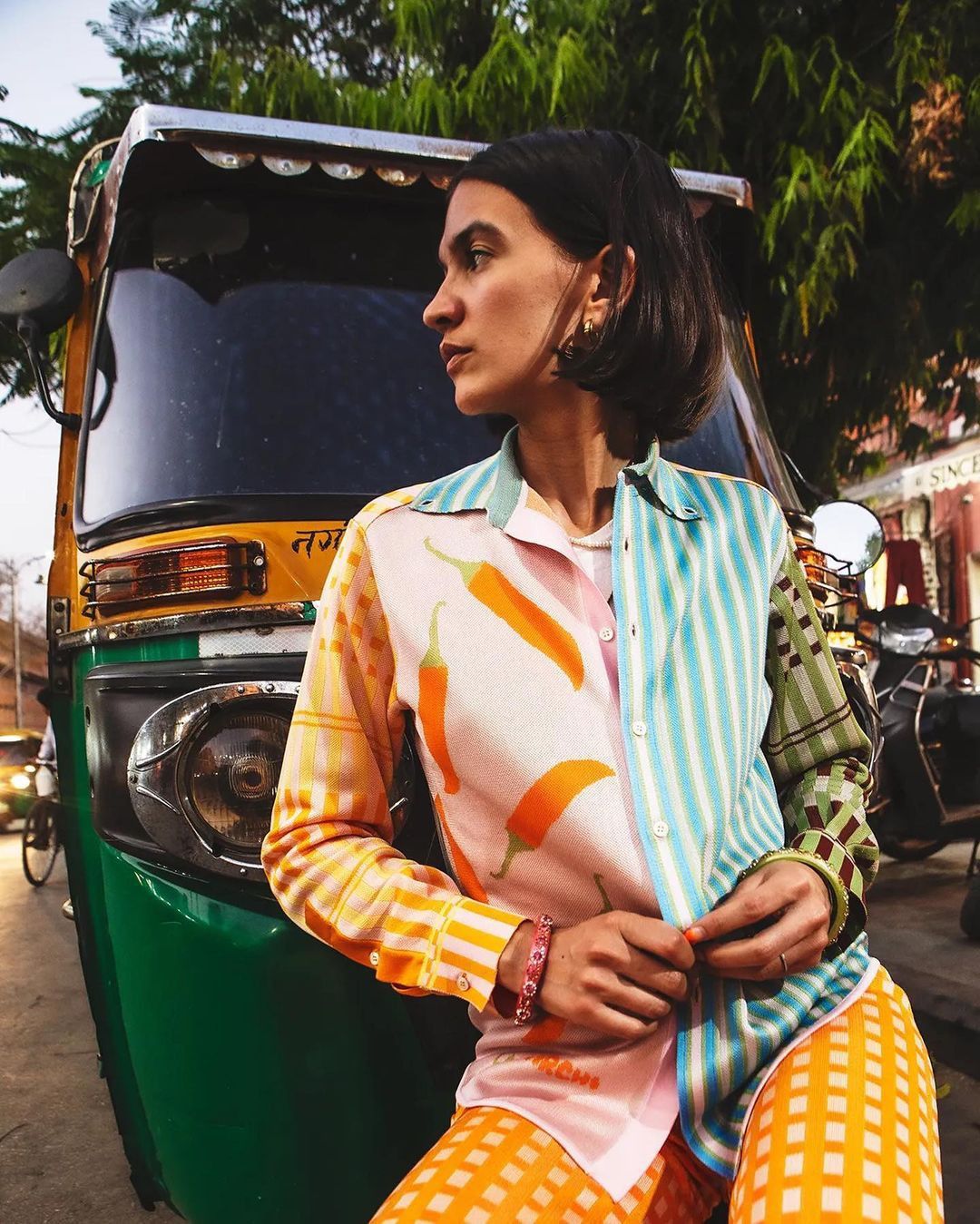 Indian street style — printed shirt against an auto-rickshaw